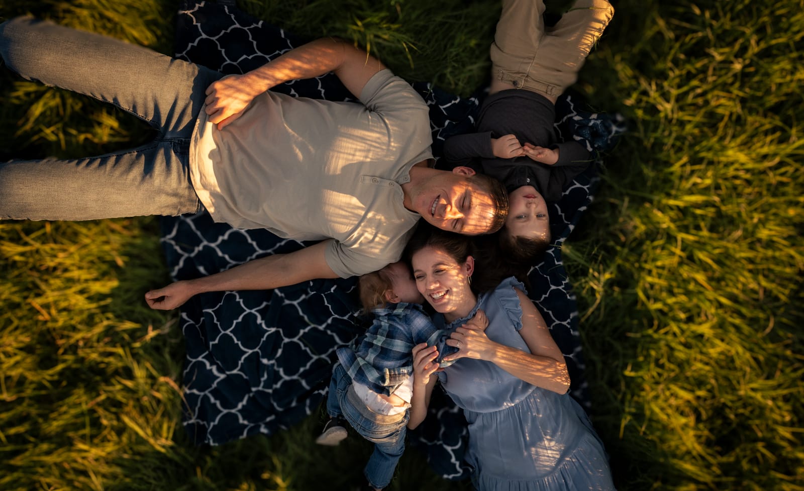 Overhead photo of a family lying together on a picnic blanket, Phoenix family photographer
