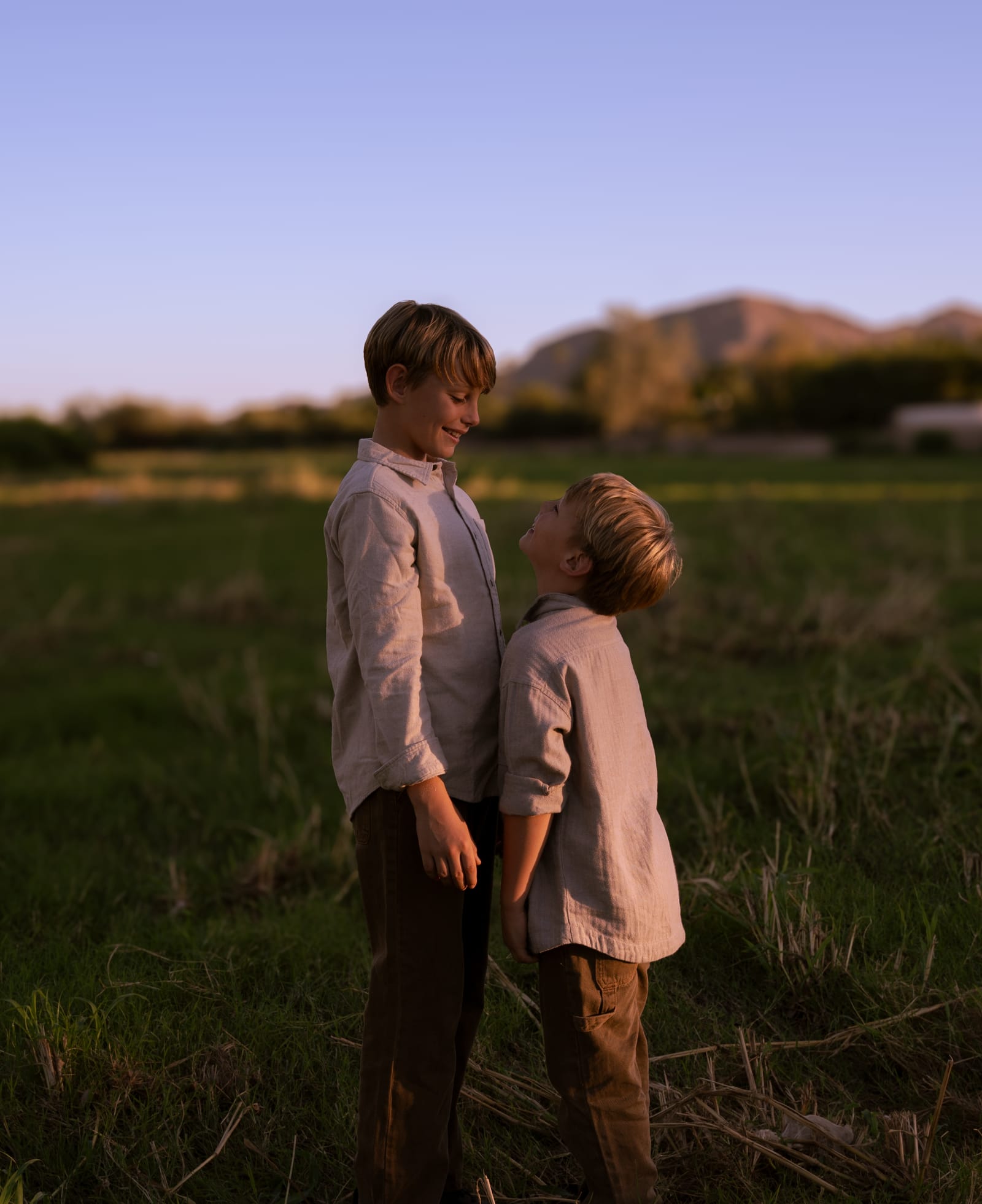 Two young brothers embracing at dusk, cinematic family photography in Phoenix, Arizona