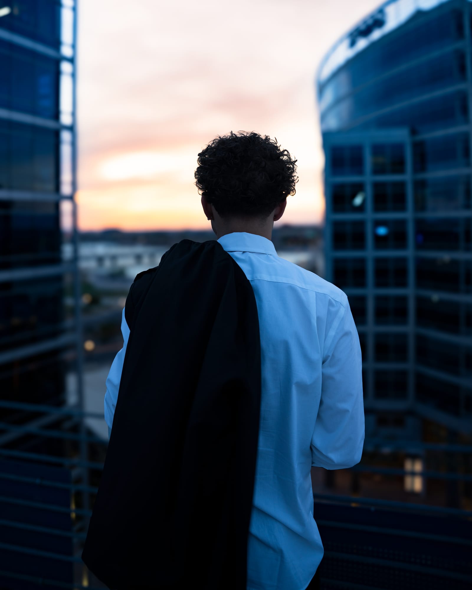Senior graduate in white shirt and red tie against modern architecture in Tempe, Arizona